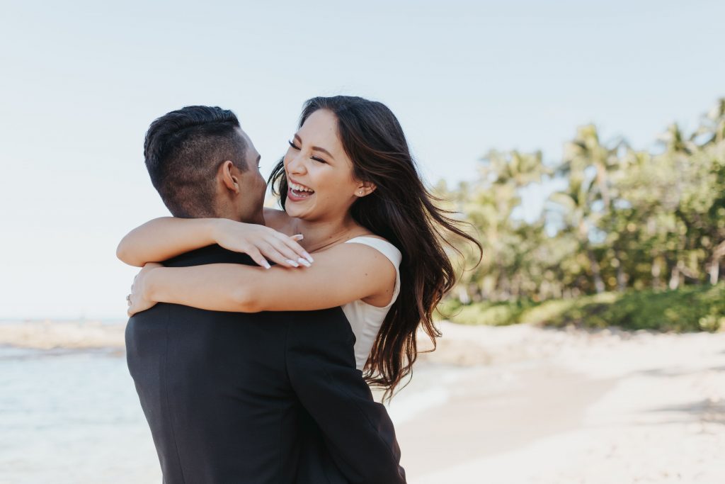 Bride and Groom laughing and hugging on the beach hawaii beach weddings by melissa meyer